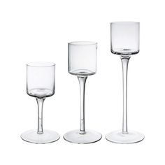 three empty wine glasses sitting next to each other