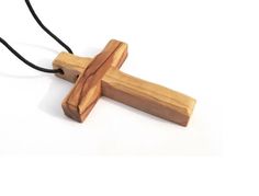 Introducing our exquisite 3 PCS Handcrafted Olive Wood Cross Necklace Set, meticulously crafted in Bethlehem, the sacred birthplace of Jesus Christ. Handmade with profound devotion by Christian families, each cross embodies a unique essence, boasting distinct textures and beveled edges that reflect its individual character. Specifications: Material: Pure olive wood trimmings sourced from the hills near Jerusalem and BethlehemCraftsmanship: Handcrafted by Christian families in BethlehemCross Size Spiritual Cross Necklace With Large Pendant, Spiritual Crucifix Necklace For Gift, Spiritual Crucifix Necklace As Gift, Handmade Cross Jewelry For Meditation, Artisan Crucifix Necklace For Gift, Spiritual Cross Necklace As Gift, Artisan Cross Pendant Necklace As Gift, Spiritual Cross Pendant Necklace, Spiritual Ankh Cross Necklace Gift