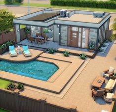 an aerial view of a house with a pool in the yard and lounge chairs around it