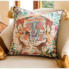 an elephant pillow on a chair with tassels