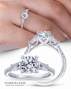 a woman's hand holding a diamond engagement ring with two side stones on it