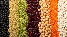 beans, peas, and lentils are arranged in a rainbow - colored pattern on display