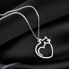 "Cat Heart Pendant Charm Necklace, Cute Heart Shaped Cat Necklace in Sterling Silver is made by hand in our workshop with care. All our jewelry is the most elegant choice for the Bridesmaids, friends, your loved ones and for yourself. Cat Heart Pendant Charm Necklace * Material: High Quality Solid 925 Sterling Silver. * Dimensions: Depending on your font choice, height sizes range from 1,5 mm to 3,5 mm lowercase. * Finish: Sterling Silver ∙ Gold ∙ Rose Gold. HOW TO ORDER ❓ * Select your necklace COLOR. * Choose necklace length from 14\" to 22\". The length option is the TOTAL chain length (including the charm). If you order an 18\" chain, the piece will come as CHAIN + CHARM = 18\".  * Finish your payment and complete your order. PRODUCTION TIME 🕒 All items made to order. Production start Silver Cat Design Jewelry For Mother's Day, Valentine's Day Cat Design Jewelry Gift, Silver Heart-shaped Cat Design Jewelry, Valentine's Day Gift Necklace With Cat Design, Valentine's Day Cat Design Necklace Gift, Valentine's Day Gift Cat Design Necklace, Wire Wrap Jewelry Designs, Necklace Cat, Cat Heart