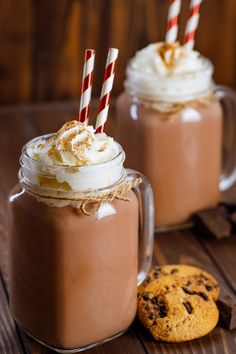 two mugs filled with hot chocolate and whipped cream