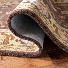 an area rug is laying on the floor with it's end rolled up and open