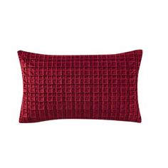 a red velvet pillow with squares on the front and back, sitting on a white background