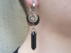 This devilishly witchy design features an obsidian crystal and a crescent moon pendant around an industrial washer. We love how the elements combine to make a design greater than the sum of its parts.  A limited 9 pair run for our Halloween collection. Sold as pairs.  Weight: 7g each (noticeable, medium weight)  Length: 7cm long  Clasp: 100% Hypoallergenic stainless steel huggies clasps.  - Our regular clasps are 10mm in diameter. We do offer larger clasps for those of you with stretched ears. P Black Obsidian Crystal, Black Crystal Earrings, Obsidian Crystal, Ear Tunnels, Crescent Moon Pendant, Moon Crystal, Season Of The Witch, Stretched Ears, Moon Charm