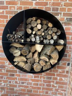 a firewood rack is mounted to the side of a brick wall with logs in it