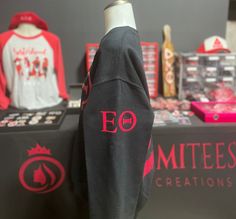 an eo hoodie is on display in front of other merchandise