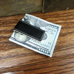 "Sturdy, flexible, and trimmed in black leather with white stitching, this personalized engraved monogram Leather Money Clip has a casual look and feel. Excellent gifts for men and groomsmen. Holds bills, credit cards, or important papers, and hides easily in a shirt or jacket pocket. Eliminates the need to carry a heavy wallet. Measures 2 1/8\" x 7/8\" x 3/8\". Please include initials to be engraved in the notes to seller box during checkout. Unless requested otherwise, all orders are shipped 1 Leather Money Clip, Leather Money Clips, Money Clips, Groomsmen Gifts, Monogrammed Leather, Monogram Gifts, Groomsman Gifts, Gifts For Men, Money Clip