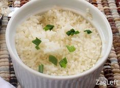 a white bowl filled with rice on top of a table