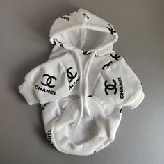 three hooded sweatshirts with chanel logos on them sitting on top of a table