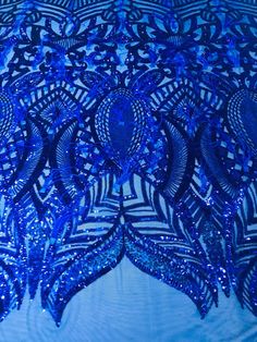 an intricately designed blue cloth with sequins on it's edges and back