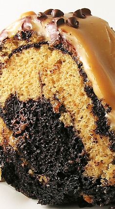 a close up of a cake with icing and chocolate chips