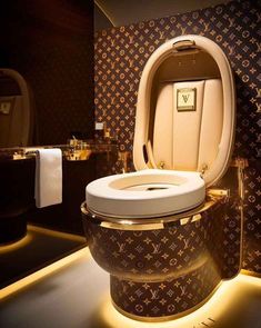 an unusual toilet in the middle of a room with gold trimmings and lights