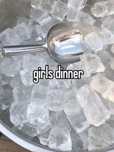 a bowl filled with ice and a spoon on top of it that says girls dinner