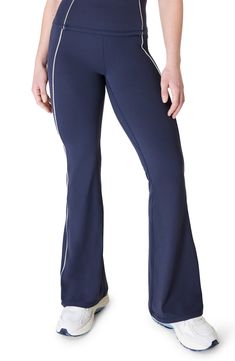 A flare-leg silhouette and scalloped piping add a sweet element to softly sculpted pants cut with plenty of stretch to move with you through your workout. 31 1/2" inseam; 23" leg opening; 10 1/2" front rise; 12 1/2" back rise (size Medium) Pull-on style 69% polyamide, 31% elastane Machine wash, dry flat Imported Stretch Bottoms With Contrast Trim For Sports, Fitted Wide Leg Blue Activewear, Stretch Sports Bottoms With Contrast Trim, Blue Fitted Wide Leg Activewear, Fitted Sports Bottoms With Contrast Trim, Sporty Flare Bottoms In Elastane, Fitted Athleisure Bottoms With Contrast Trim, Sporty Blue Wide Leg Yoga Pants, Blue Flare Pants With Elastane