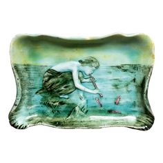 a glass plate with a child holding a fish