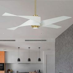 a ceiling fan with two white blades hanging from it's side in a kitchen