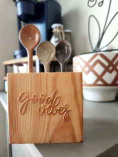 spoons are sitting in a wooden holder on a counter