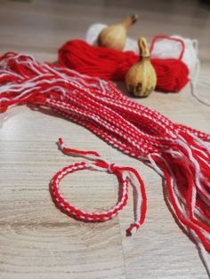 some red and white string sitting on top of a wooden table