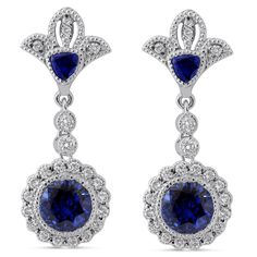 Two dazzling round cut medium blue sapphires are bezel set in this unique royal style drop down earring mounting with round cut diamonds and hand engraved fine milgrain accents. 
 
  These earrings are custom made to order and can be modified to fit your needs  .      MAIN GEM   Gem: Sapphire 
 Shape: Round 
 Carat Weight: 6ctw 
 Size: 7mm 
 Color: Medium Blue Dark Blue 
 Clarity: 
 Earring Style: Screw Back 
 Earring Style: Screw Back    ACCENT STONES   Gem: Diamond 
 Shape: Round 
 Carat Weight: 1.00ctw 
 Color: H 
 Clarity: SI1    ADDITIONAL INFORMATION   Style #: ER201 
 Additional Information: These earrings are customizable and can be modified to fit your needs Royal Style, Blue Sapphire Diamond, Best Diamond, Style Earrings, Screw Back Earrings, Royal Fashion, Sapphire Diamond, Hand Engraving, Round Cut Diamond