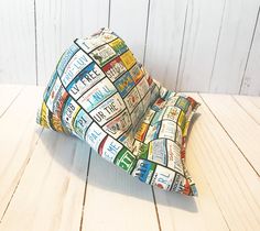 a pillow made out of newspapers sitting on top of a wooden floor