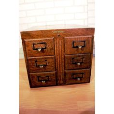 an old wooden file cabinet with four drawers