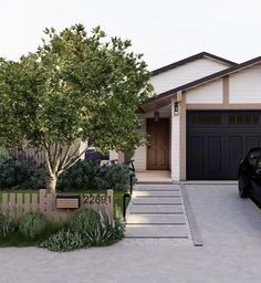 a black car parked in front of a house with a tree and bushes around it