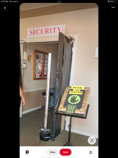 an open door with a sign that says security in front of it and a cell phone next to it