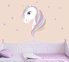 a bedroom with pink walls and a white horse head on it's wall decal