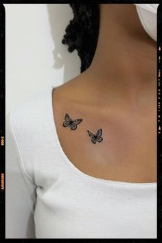 a woman's chest with two butterflies tattoo on her left upper back side neck