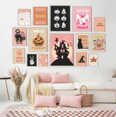 a living room filled with lots of posters on the wall above a white couch and coffee table