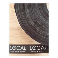 the local surf logo is on top of a roll of black tape