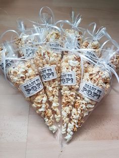 several bags of popcorn sitting on top of a wooden table