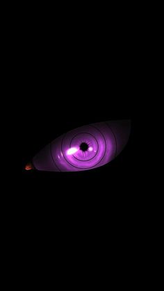 a purple object floating in the dark with its light on it's side,