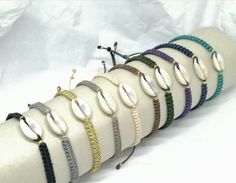 Tiny cowrie shell macrame bracelet  * 15mm natural cowrie shell  *macrame weaved with waxed cord in many colors to choose from *unisex *adjustable size, fits S, M, L size  * if you have an extra small or extra large wrist / hand, please let me know so I can adjust the size properly! ------------------------------------------------------------------------------------------------ I use REGISTRED MAIL (tracking number and recipient's signature required) only.  All domestic orders have a tracking nu Handmade Adjustable Shell Friendship Bracelets, Handmade Cowrie Shell Friendship Bracelets As Gift, Beach Braided Bracelets With Macrame And Waxed Cord, Handmade Shell Friendship Bracelets, Casual Macrame Bracelets For Beach, Casual Macrame Friendship Bracelets For Beach, Handmade Bohemian Cowrie Shell Friendship Bracelets, Handmade Waxed Cord Friendship Bracelets For Beach, Extra Petite