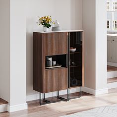 a wooden cabinet sitting in the middle of a living room next to a white rug