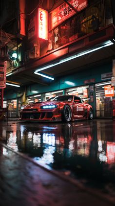 a red sports car is parked in front of a building at night with neon lights