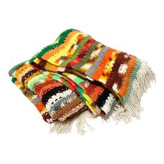 multicolored throw blanket with fringes on white background