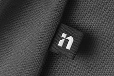 closeup of the black and white logo on a suit