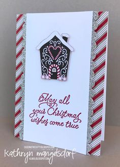 a christmas card with a house and candy canes