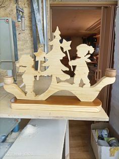 a wooden carving of a boy and girl on a sleigh