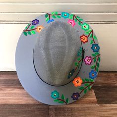 Stay stylish in this beautiful colorful hand painted straw hat, ideal for any sunny day occasion. Every single hat is hand painted uniquely which means there will never be another one like it. MADE IN MEXICO By: Mexican Artisans For: Women Size: Medium (23") Color: gray | multi Details: Material: Palm Straw Leather Band Inner elastic band Contact us for more details PLEASE READ BEFORE PURCHASE: Each product is handmade from Mexico causing differentiation and minor imperfections in each piece mak Artistic Hand Painted Adjustable Straw Hat, Artisan Hand Painted Brimmed Sun Hat, Hand Painted Bohemian Brimmed Straw Hat, Hand Painted Hats For Spring, One Size, Bohemian Hand-painted Straw Hat For Spring, Painted Hats, Straw Hat, Leather Band, Sunny Days