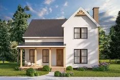 a white two story house sitting on top of a lush green field