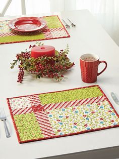 the table is set with placemats, plates, and cups for christmas dinner