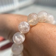 "Ultra High quality, gem grade white sakura agate/white flower agate beaded bracelet, 11mm width. Only one available, you get the exact bracelet listed. Standard 7 inch size but can be customized slightly larger or smaller. Flower Agate encourages self-growth.  It protects against fear and self-doubt.  Aids in manifestation. Perfect stone for Entrepreneurs. Helps you reach your highest potential. Comforting and grounding. Encourages you to pursue your dreams. Restores emotional balance. Helps wi White Crystal Bracelet With Gemstone Beads As Gift, White Round Crystal Bracelet Gift, White Elegant Crystal Bracelet With Natural Stones, Elegant White Crystal Bracelet With Natural Stones, White Crystal Bracelet With Natural Stones For Gift, White Crystal Bracelet With Natural Stones As Gift, White Crystal Bracelet With Gemstone Beads For Healing, Elegant White Crystal Bracelet For Healing, Handmade White Crystal Round Bracelet