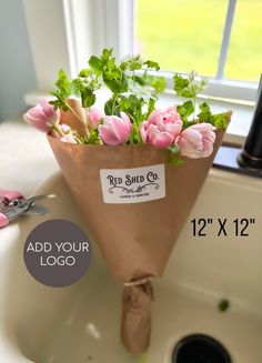 a bouquet of pink flowers sitting on top of a white sink