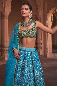 Turquoise blue flared lehenga with all over edelweiss garden embroidery using mirror, cutdana, sequin highlights and comes with a separate cancan. Paired with a sleeveless plunging round neck padded blouse with sequin-beads floral vine embroidery and dangling glass beads on the hem and ditsy sequin floret embellished tasselled border dupatta. - Aza Fashions Blue Sleeveless Lehenga For Navratri, Blue Sleeveless Lehenga For Diwali, Blue Sleeveless Set For Festivals, Festive Turquoise Embroidered Lehenga, Festive Embroidered Turquoise Lehenga, Fitted Turquoise Lehenga For Reception, Festive Turquoise Choli For Reception, Turquoise Lehenga With Pallu, Fitted Turquoise Lehenga With Dupatta