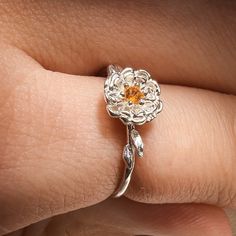 "Title: Chrysanthemum November Birth Month Flower Ring with Citrine Birthstone Material: Material:  Solid 14k Yellow Gold, 14k White Gold, 14k Rose Gold or solid 925 Sterling Silver.  18k and 9k Gold are available upon request. Timeline: Custom made to order (2 weeks) Size:  Stone: 2 mm genuine AA grade brilliant cut and 1.2-3 solid round band Special Options: I offer different gemstones upon request  Story: Chrysanthemum represents a long and joyful life, while its beautiful blooms symbolize au Flower Shaped Gemstone Ring For Anniversary, Gemstone Flower Ring For Anniversary, Elegant Sterling Silver Flower Ring With Birth Flower, Dainty Citrine Wedding Jewelry, Dainty Citrine Jewelry For Weddings, Flower-shaped Jewelry With Prong Setting For Anniversary, Fine Jewelry Flower Ring With Birth Flower For Gift, Birth Flower Ring For Gift In Fine Jewelry Style, Flower Shaped Prong Setting Jewelry For Anniversary